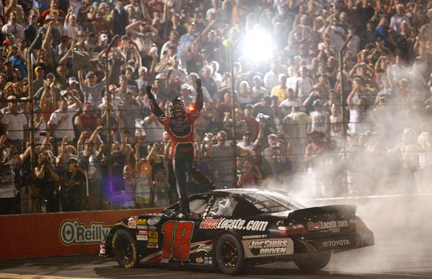 Kyle Busch salutes the fans after doing a burnout to celebrate his Kroger 200 win at O'Reilly Raceway Park. Credit: Tom Pennington/Getty Images for NASCAR